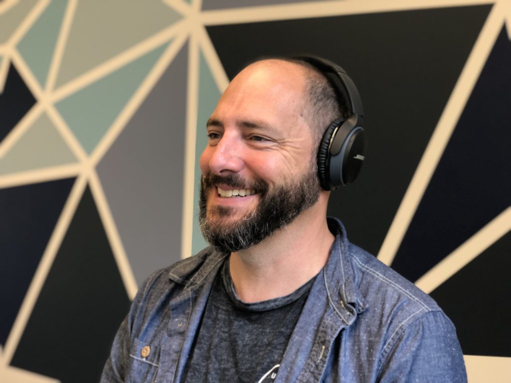 CXO, John Gentle, working with headphones on.